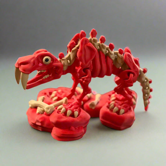 Red dinosaur skeleton model on a black surface with blurred background